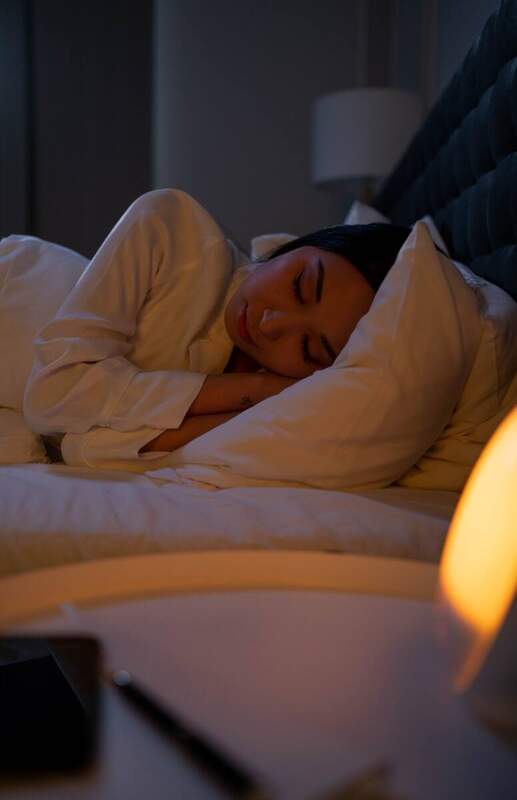 Woman sleeping peacefully after overcoming perimenopause insomnia